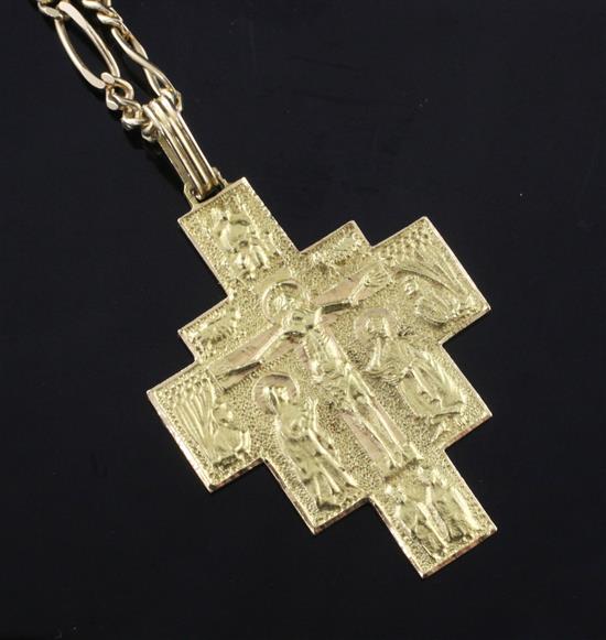 An 18ct gold crucifix pendant, on an 18ct gold figaro link chain, chain 35in.